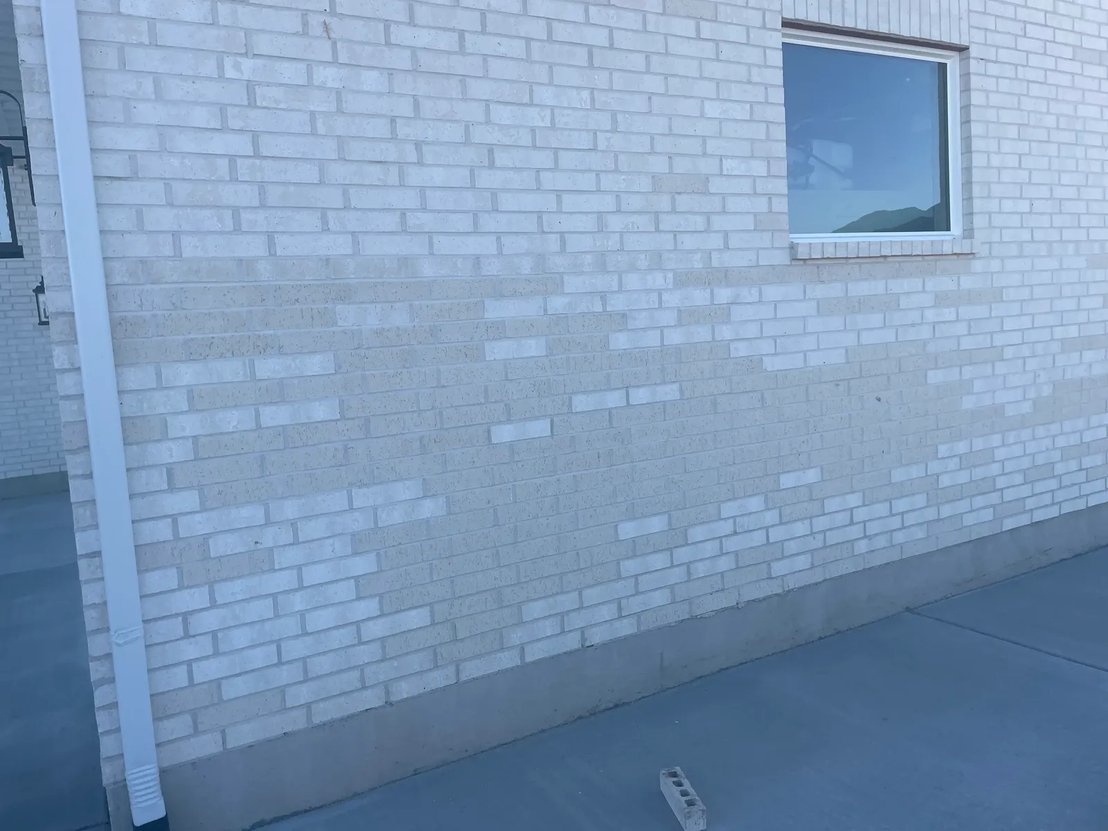 Before: worn tan brick exterior prior to modern staining transformation in Utah